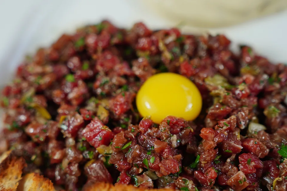 BookNoFees: Example photo: Steak tartare topped with egg yolk and served with toasted bread